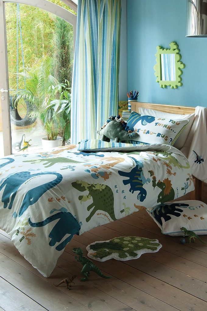 Dinosaur themed bedroom featuring children's bedding